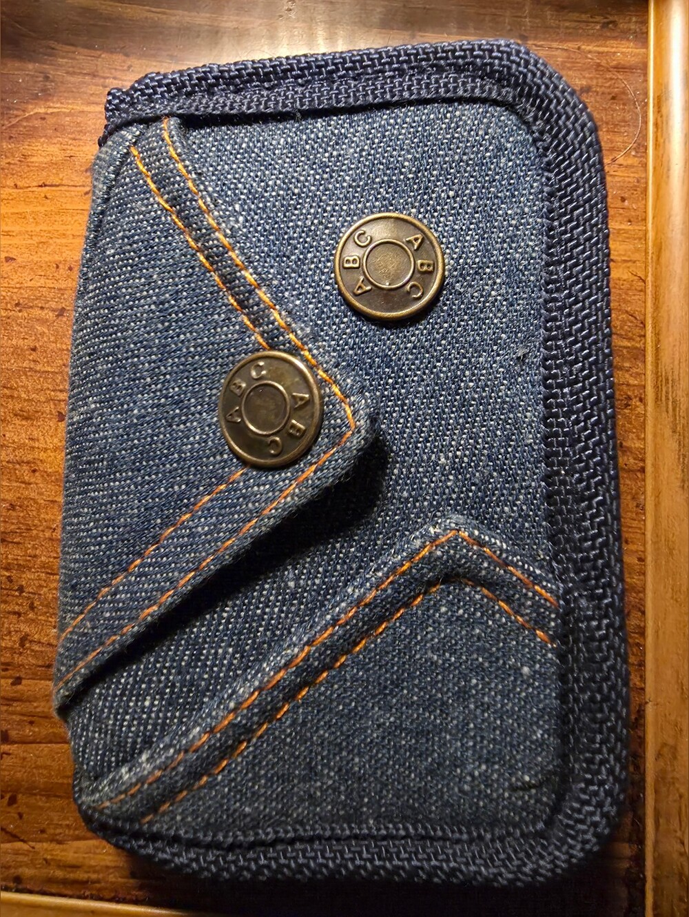 Blue denim wallet, miniature jeans-style pocket and brass snap buttons